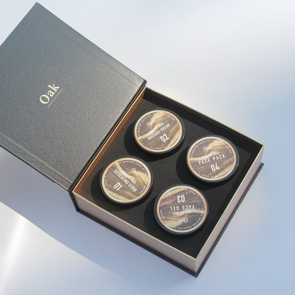 Set of four round metallic items in a 'Oak' branded box on a light blue background