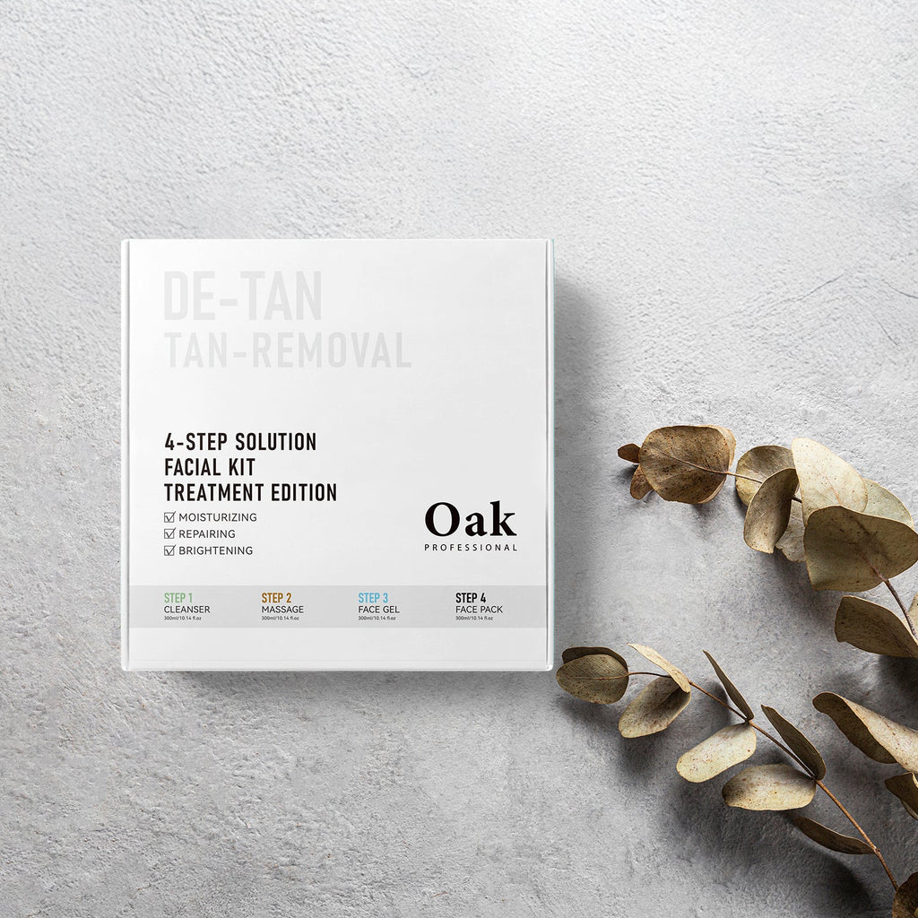 Oak Professional de-tan tan removal facial kit on a light gray surface with dried leaves.