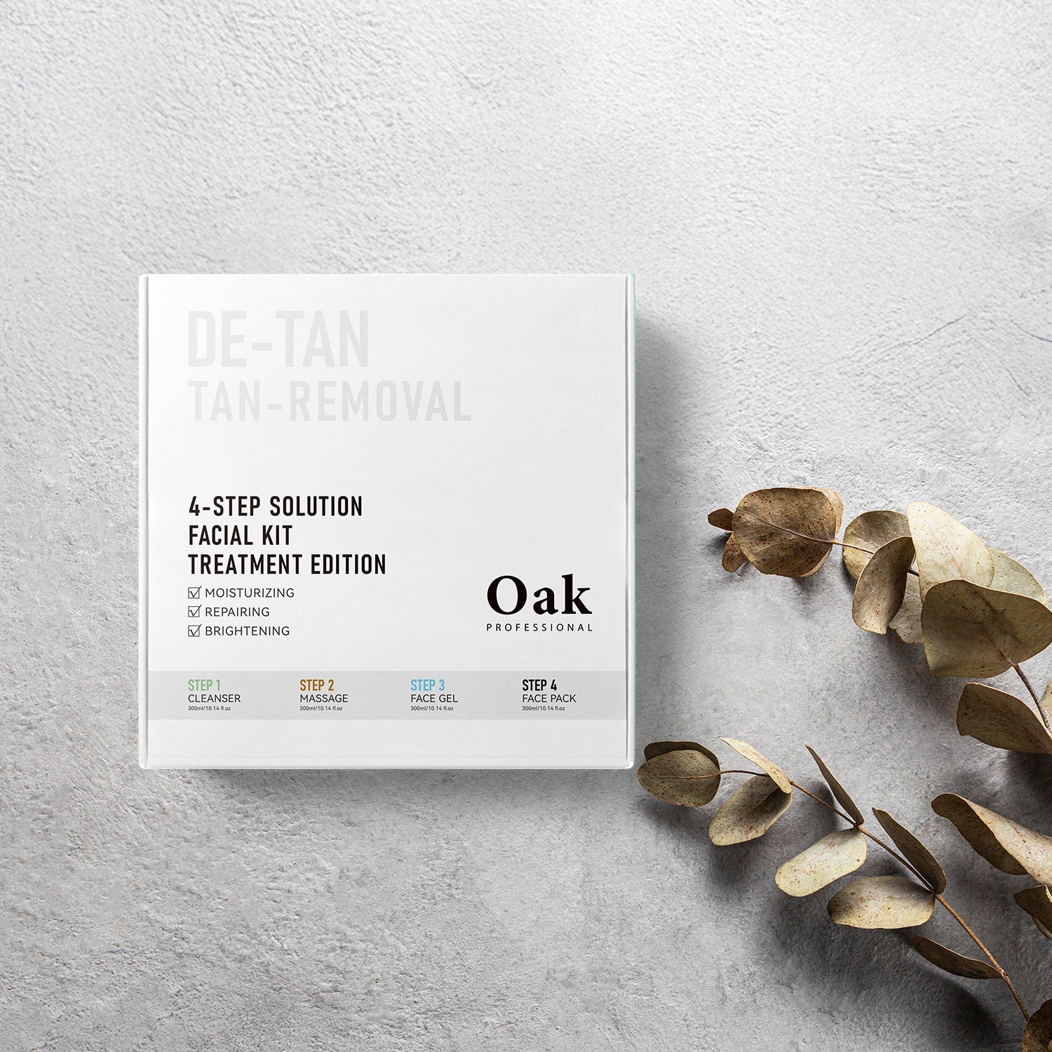 Oak Professional de-tan tan removal facial kit on a light gray surface with dried leaves.
