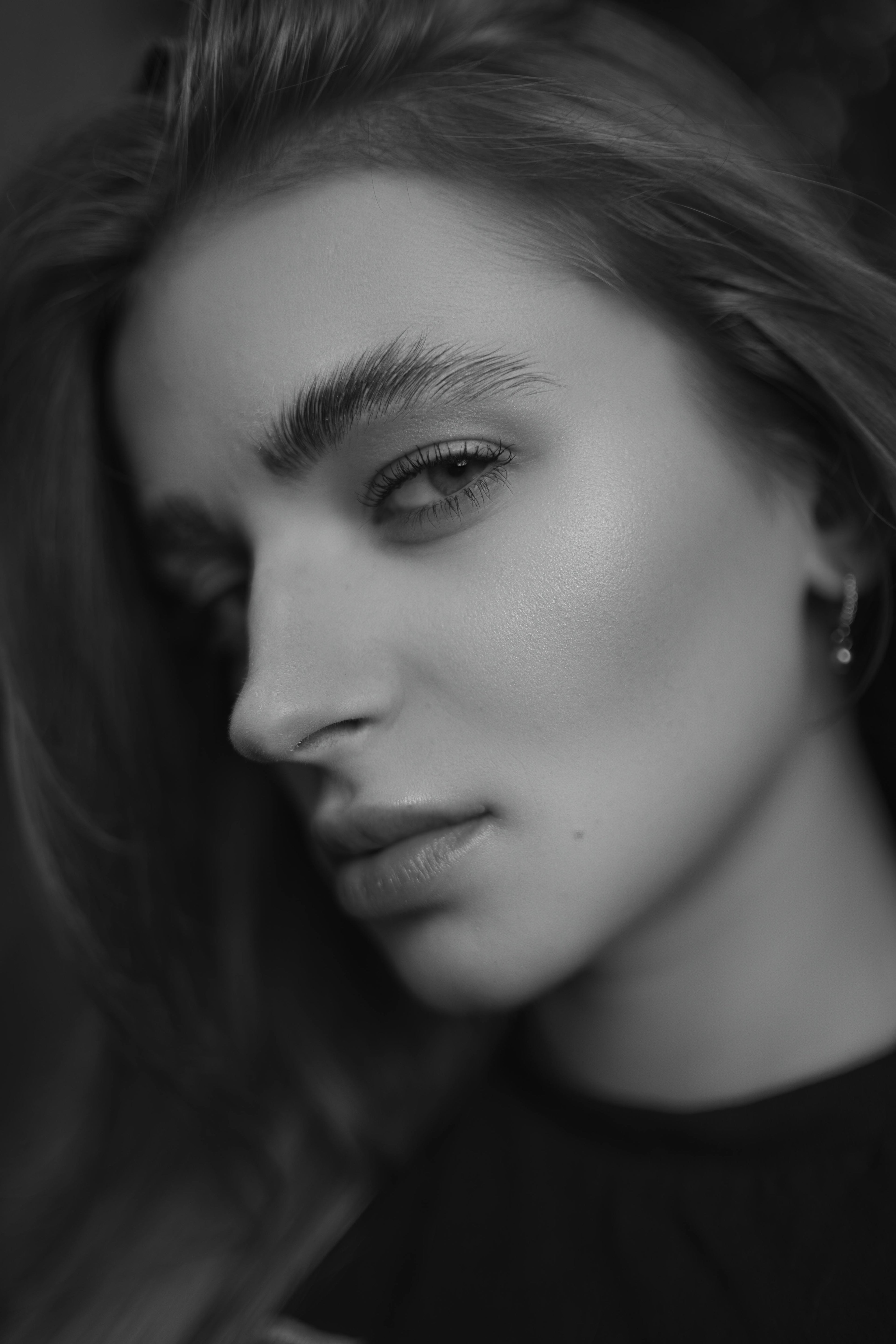 Black and white close-up of a person with a soft focus on the hair.